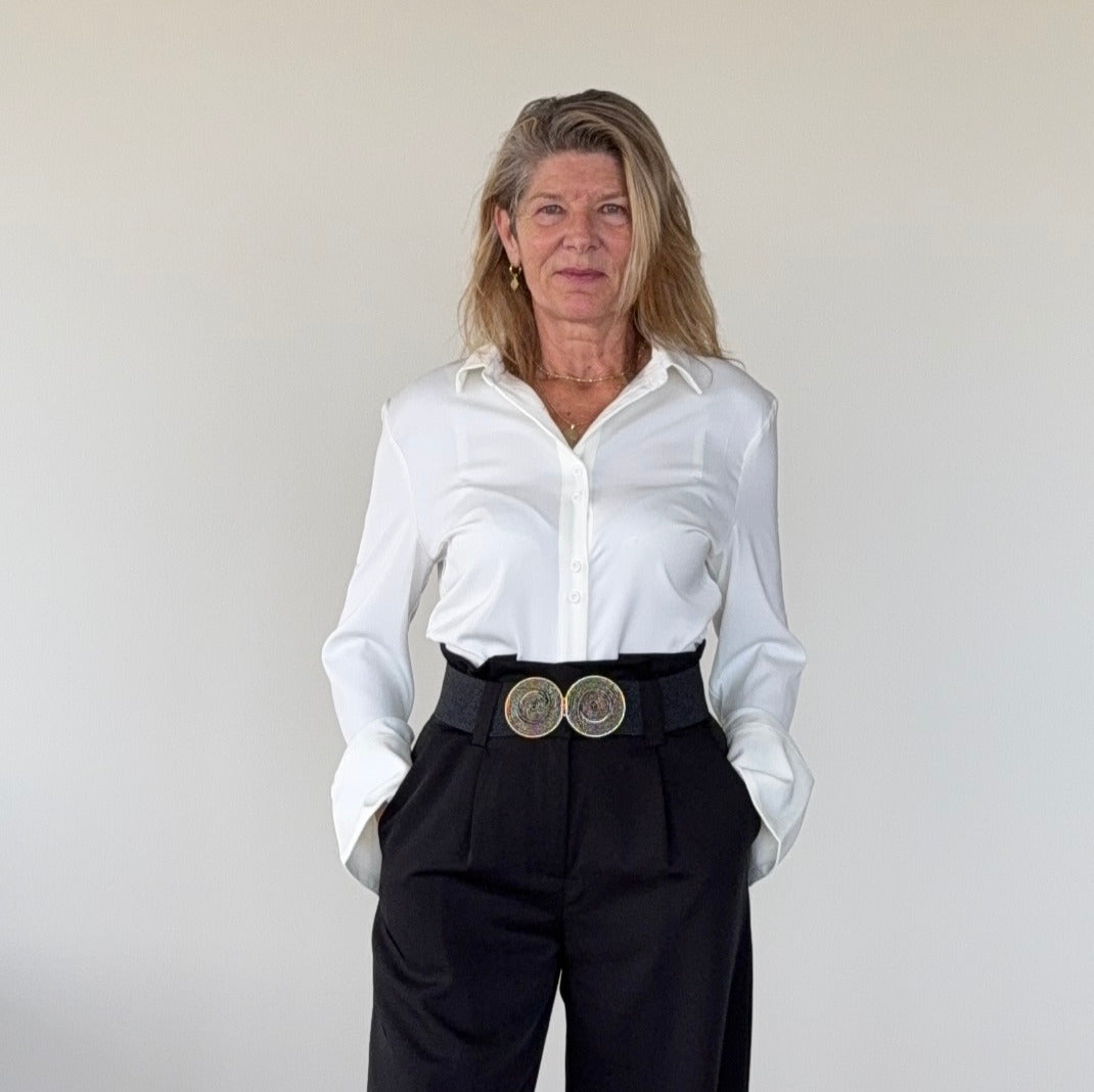 White long sleeve shirt women Australia - doesn't show sweat. Flare cuff, cinched waist. Tucked into black pants with wide belt. Tested in real life. Cheeky Goddess.