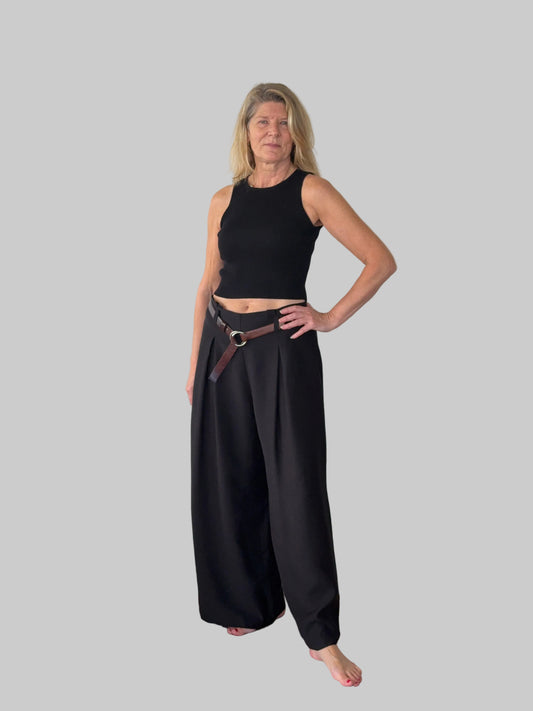 Black flowy wide leg pants women - front view - pleated detail - with belt and black knit tank top - Cheeky Goddess Australia