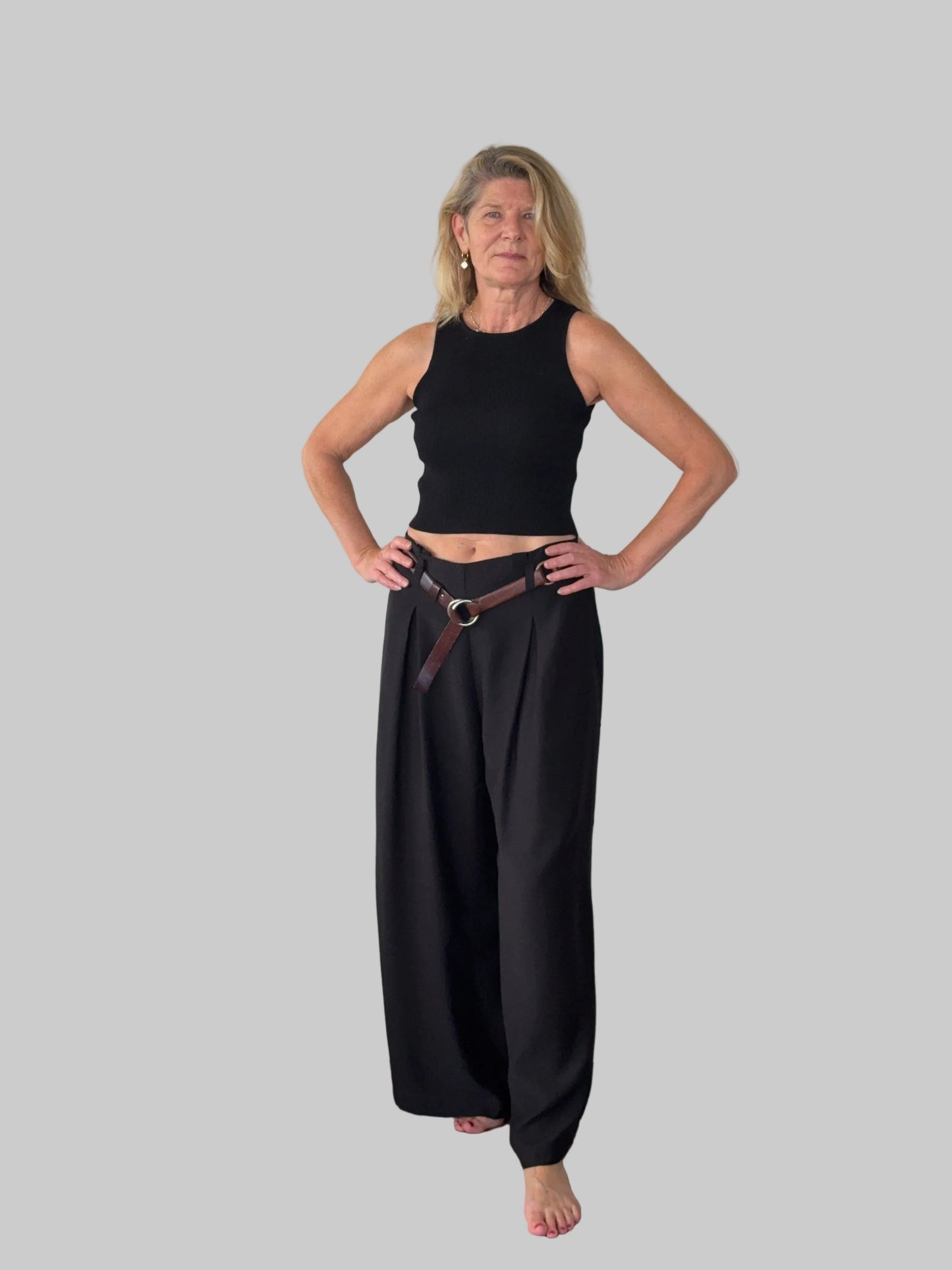 Black flowy wide leg pants women - front view - pleated detail - with belt and black knit tank top - Cheeky Goddess Australia