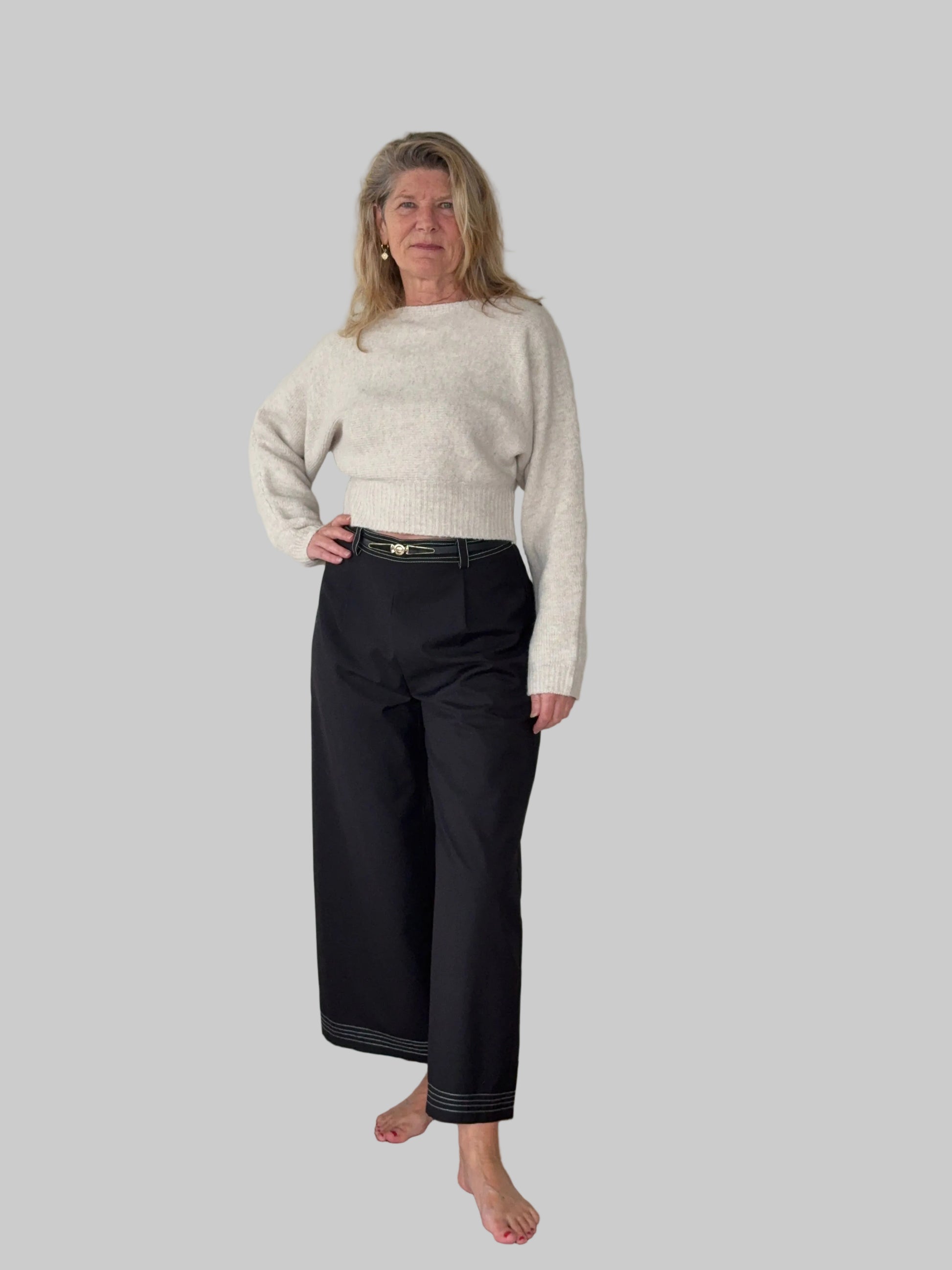 Oversized oatmeal colored batwing knit top with boat neck -women - styled with black wide leg capris pants and belt - front view - Cheeky Goddess Australia
