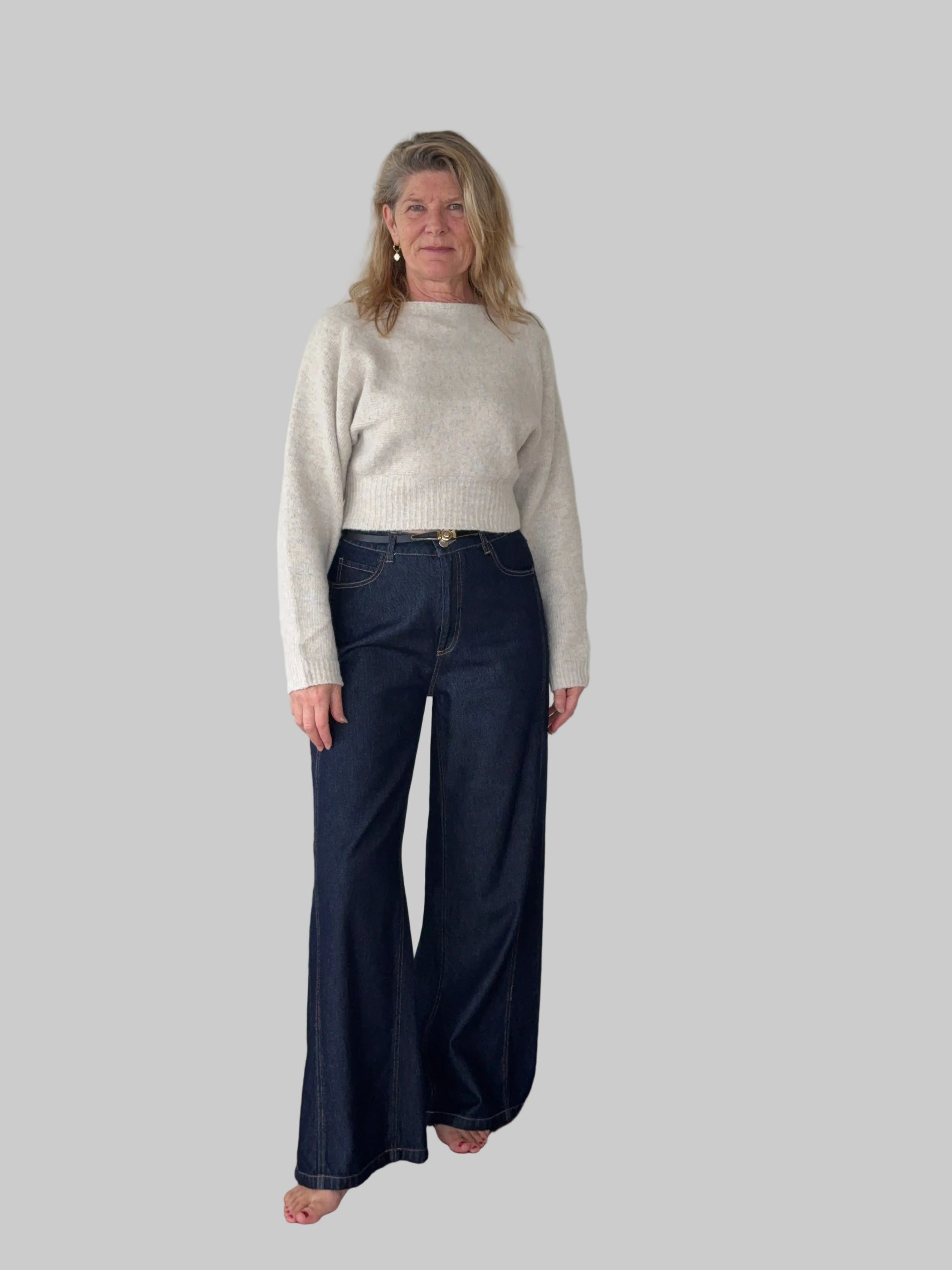 Oversized oatmeal colored batwing knit top with boat neck - women - styled with dark blue denim jeans and belt - front view - Cheeky Goddess Australia
