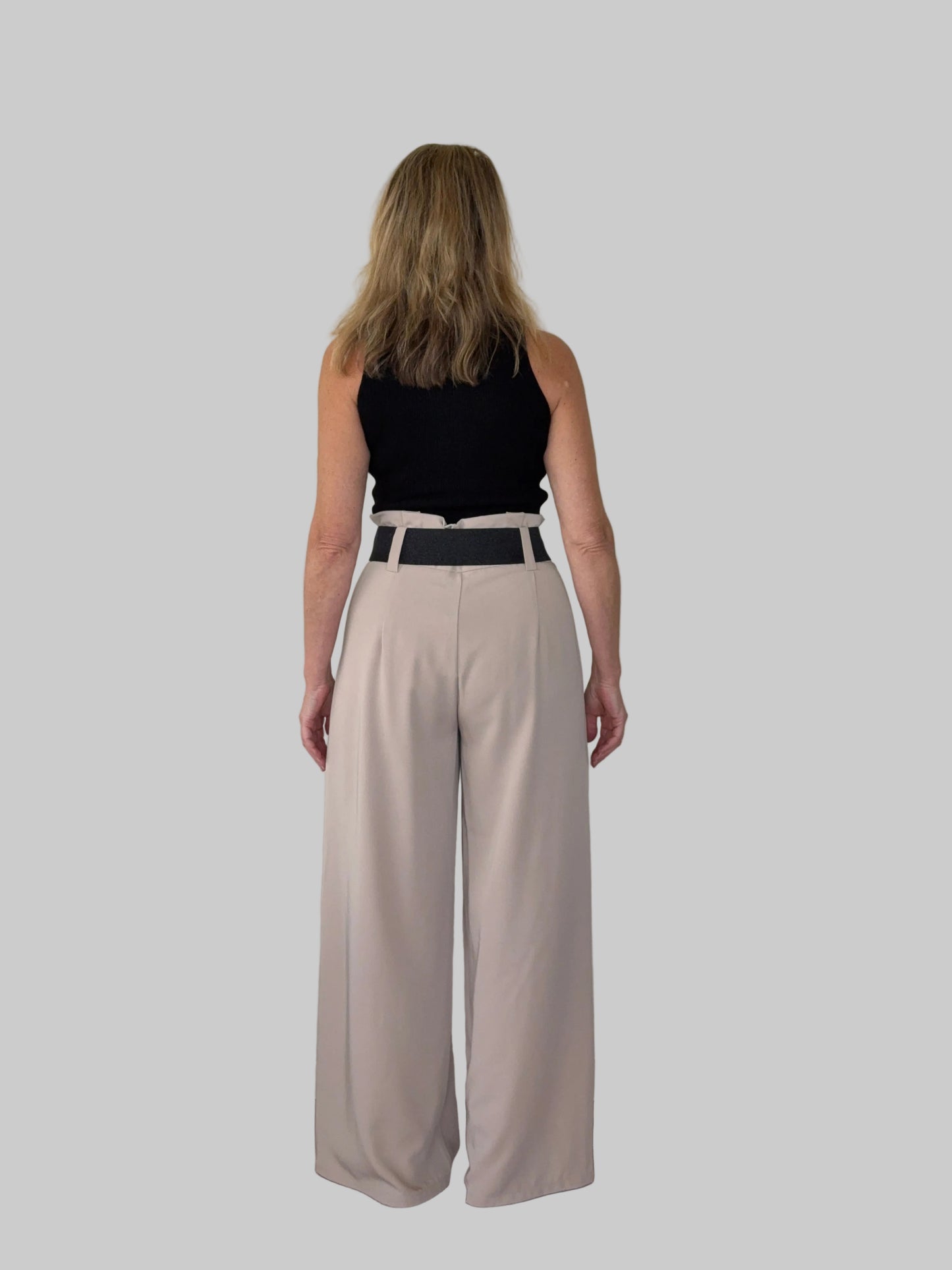 Beige paper bag waist pants women - back view - flattering wide leg - with wide belt and black tank top - Cheeky Goddess Australia