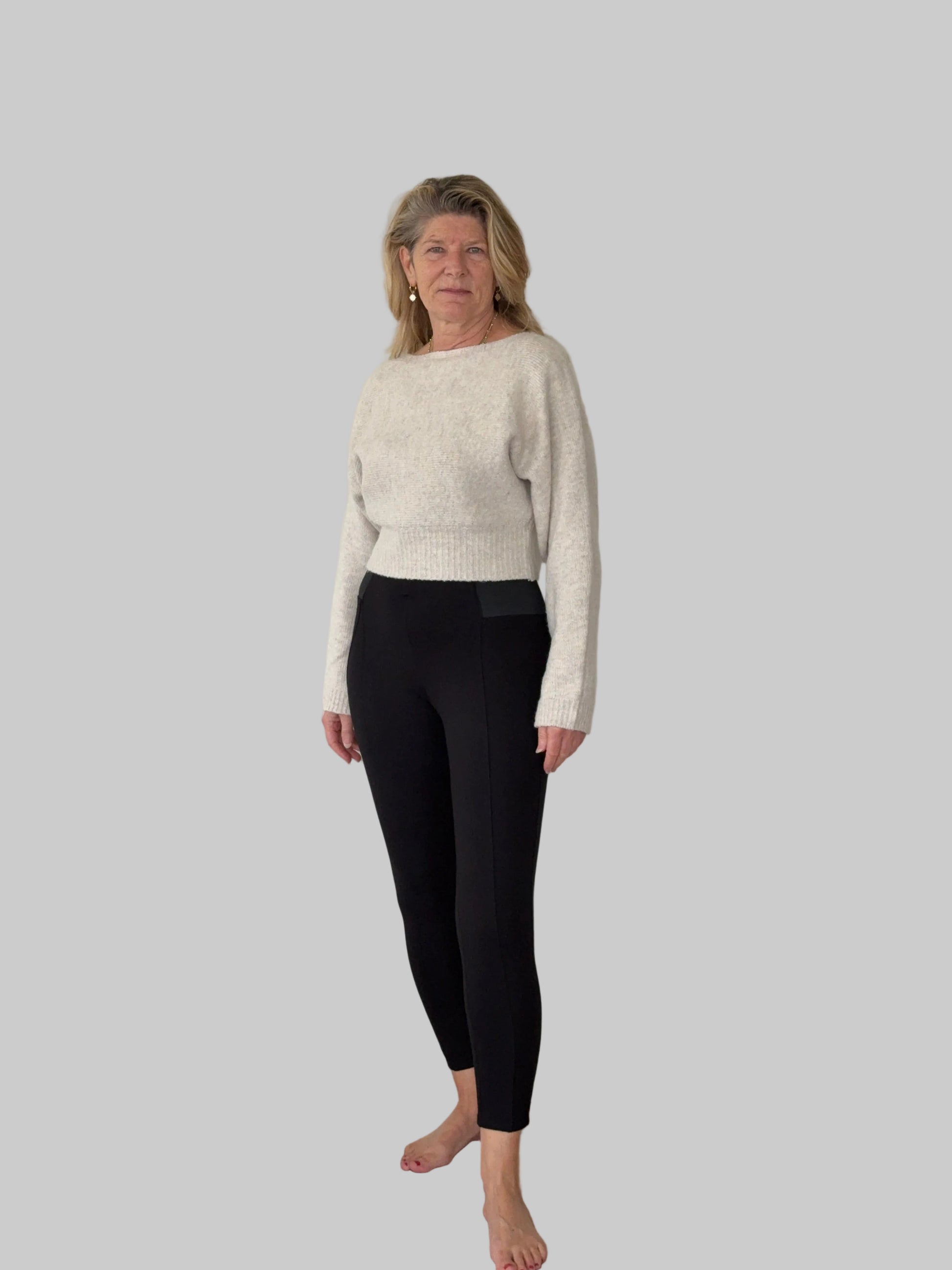 Oversized oatmeal colored batwing knit top with boat neck - women - styled with black leggings - front view - Cheeky Goddess Australia