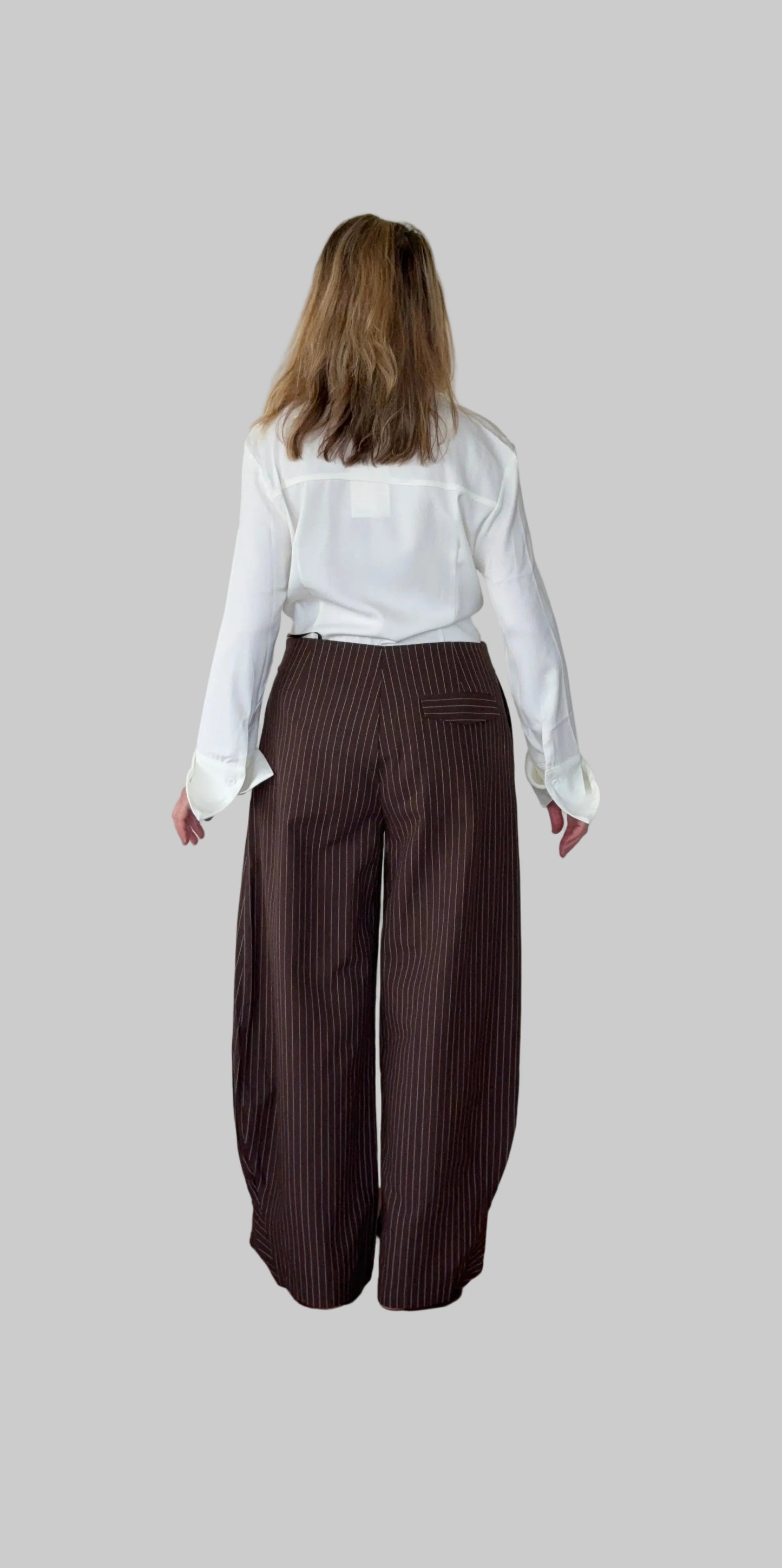 White long sleeve shirt women Australia - doesn't show sweat. Flare cuff, cinched waist. Tucked into brown barrel pants.  Back view. Tested in real life. Cheeky Goddess.