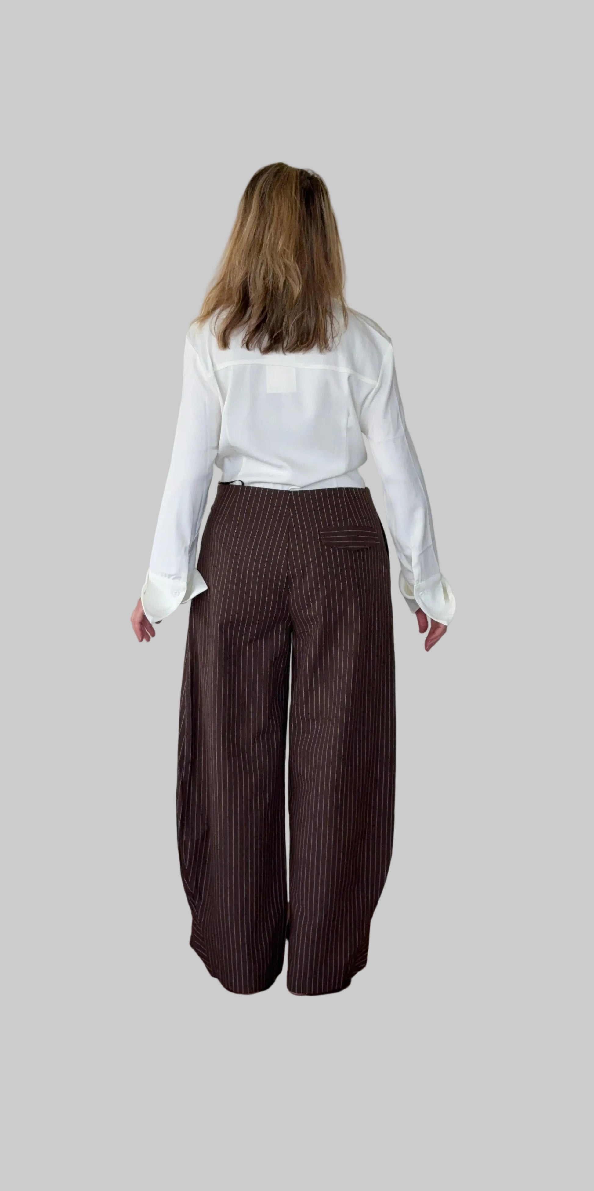 White long sleeve shirt women Australia - doesn't show sweat. Flare cuff, cinched waist. Tucked into brown barrel pants.  Back view. Tested in real life. Cheeky Goddess.