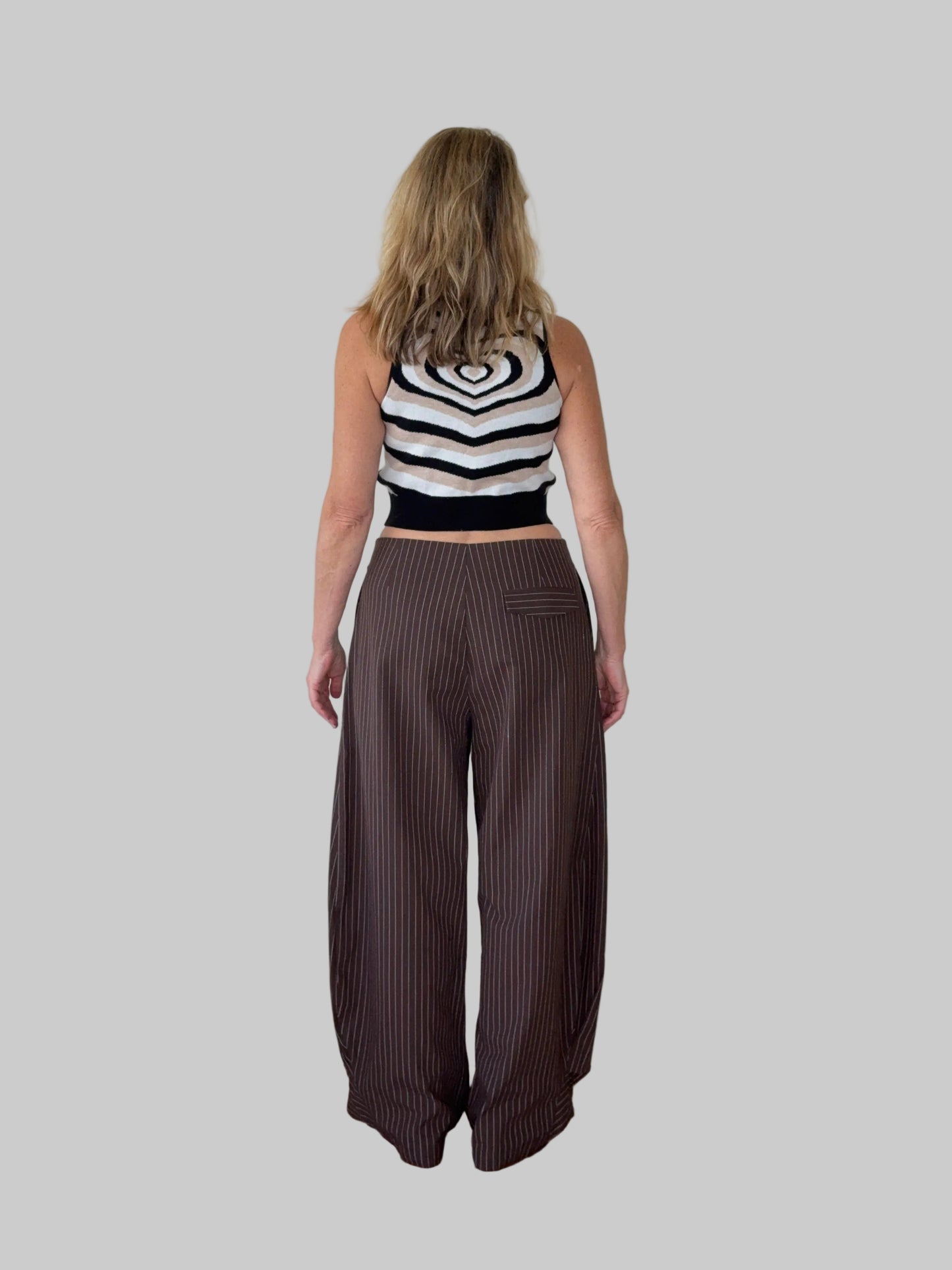 Brown linen pants styled with geometric black white and cream knitted tank top - back view - women over 50 Australia - Cheeky Goddess