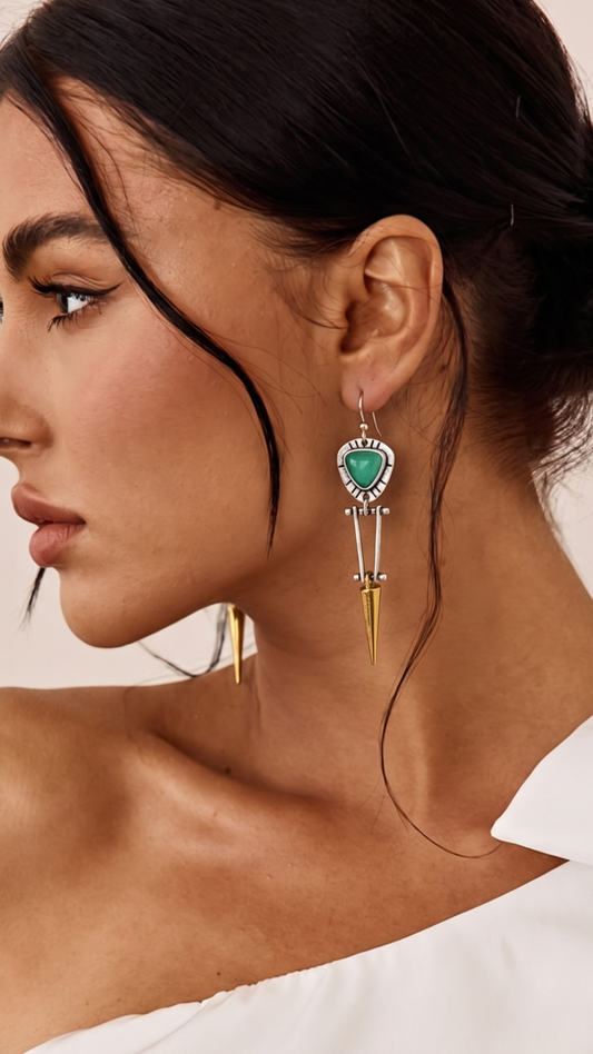 drop earring with green and gold accents. Sterling silver earwires earrings are on a model looking sideways Model has a white off the shoulder top on. Cheeky Goddess.