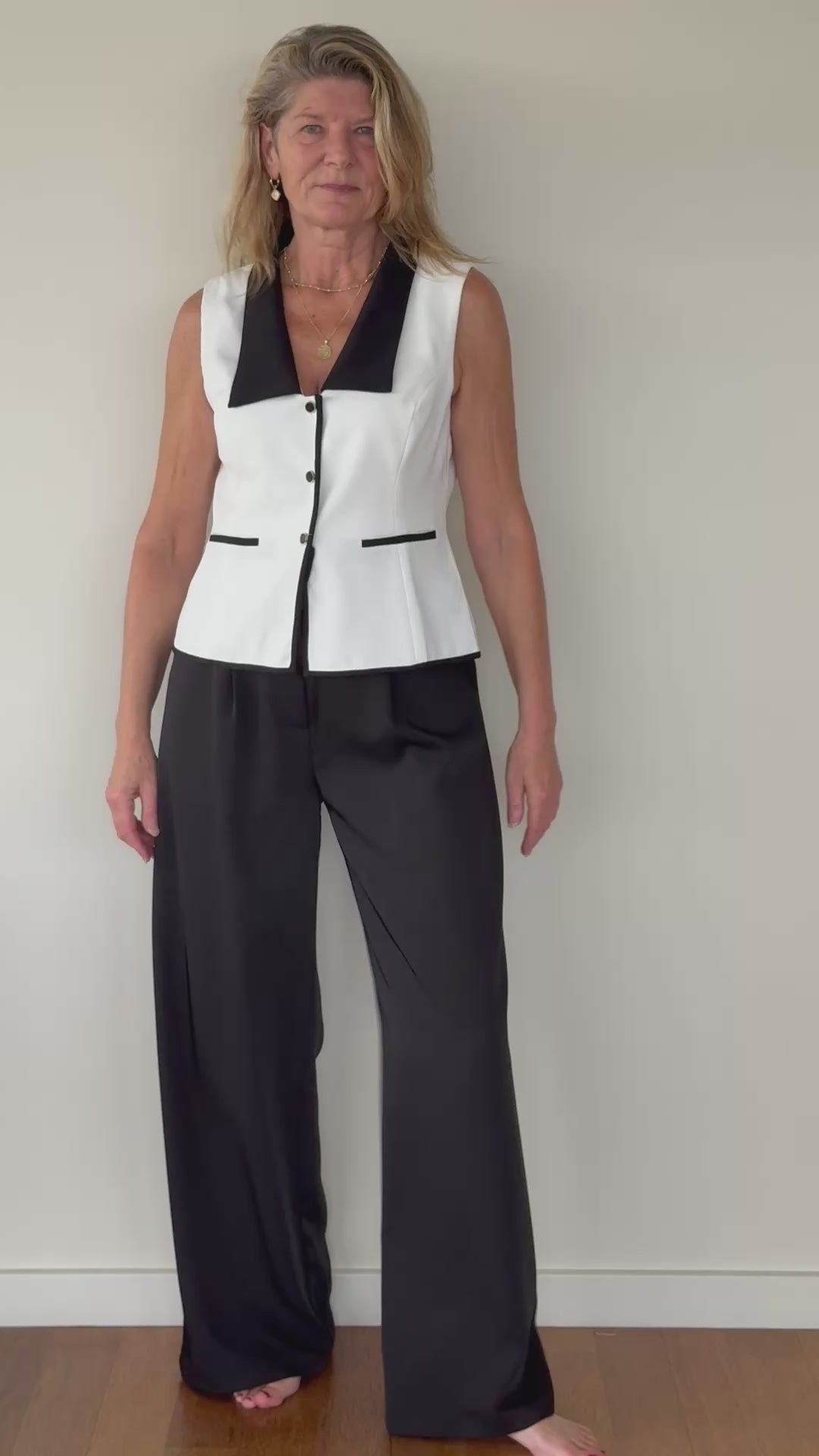 Video of woman in tailored white vest with black contrast - with black paperbag ide leg pants.  Cheeky Goddess - Vida - size 14 - Australia