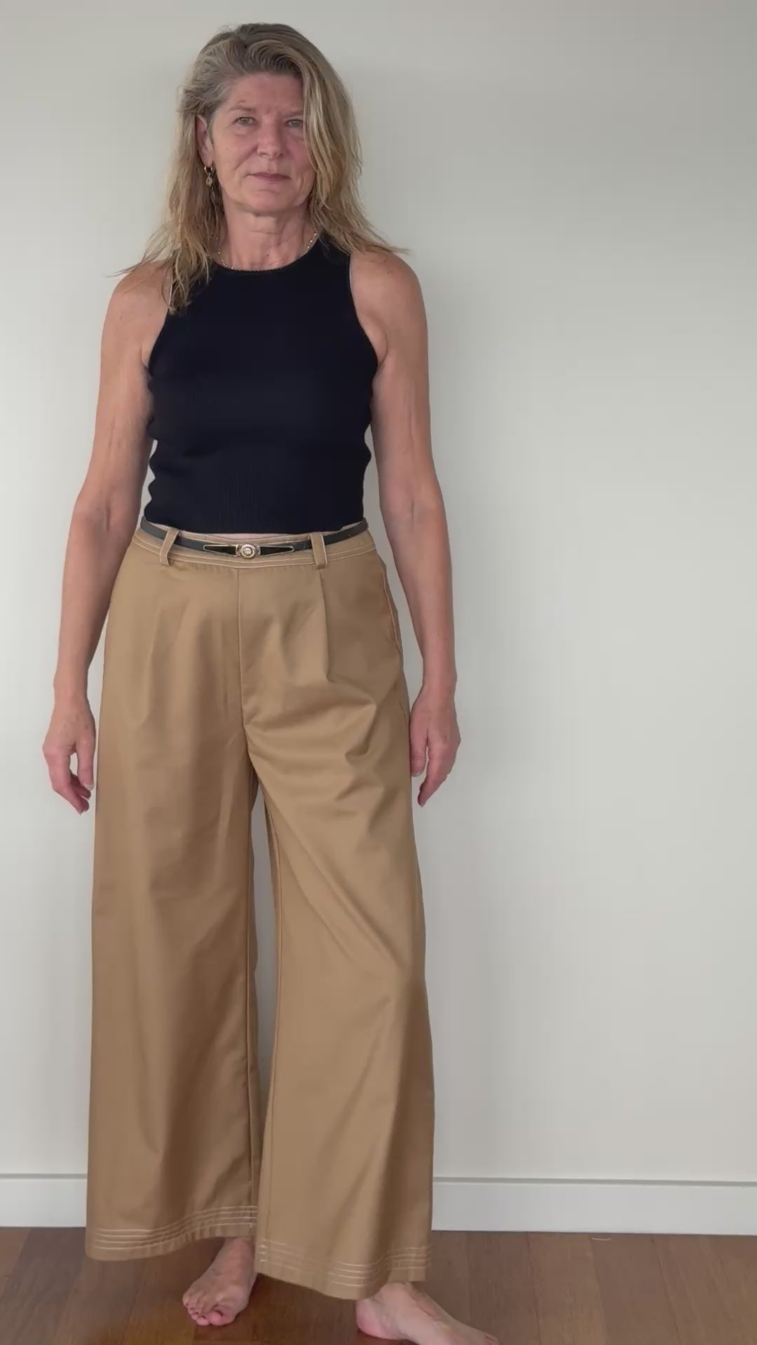 Video of woman in mocha brown wide leg pants with white stitching - with black belt and black knit tank top.  Cheeky Goddess - Vida - size 14 - Australia