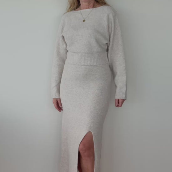 Video of woman in an oatmeal coloured knit set of long sleeved top and skirt with split.  Cheeky Goddess - Vida size 14 Australia