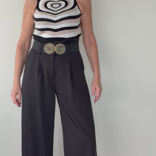 Video of woman with geometric knit tank top with heart design in neutral colours with black wide leg tailored pants with black belt.  Cheeky Goddess - Vida size 14 Australia